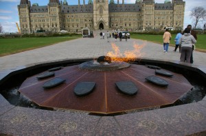 The flame with the Parliament Buildings behind it